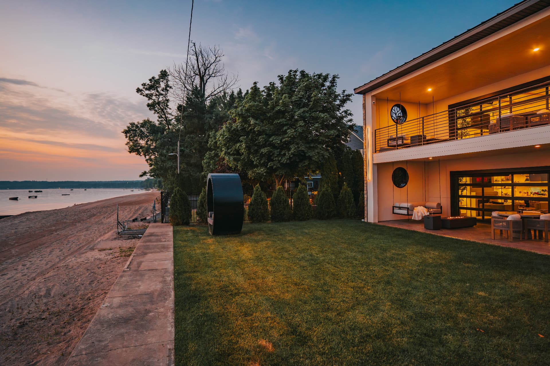 Private lawn and fifty feet of beach frontage alongside the villa at sunset