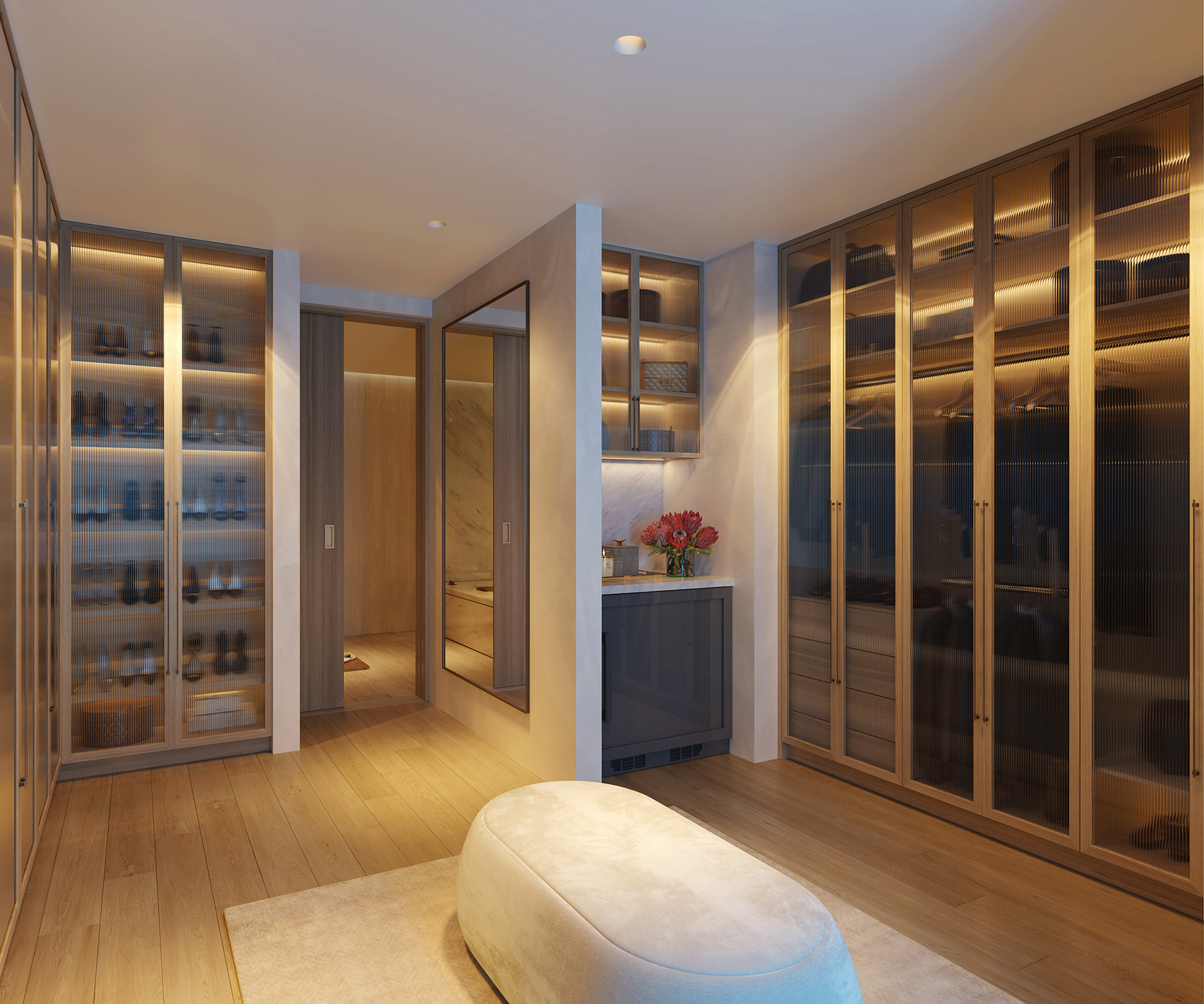 Custom walk-in wardrobe with backlit fluted glass cabinetry