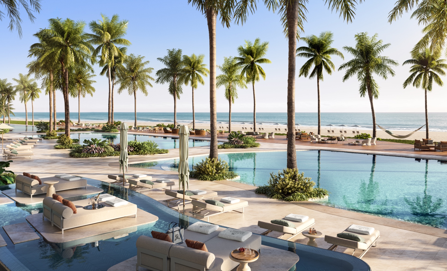 East oceanfront pool deck with palm-lined beachfront at the St. Regis Residences, Sunny Isles Beach, Miami