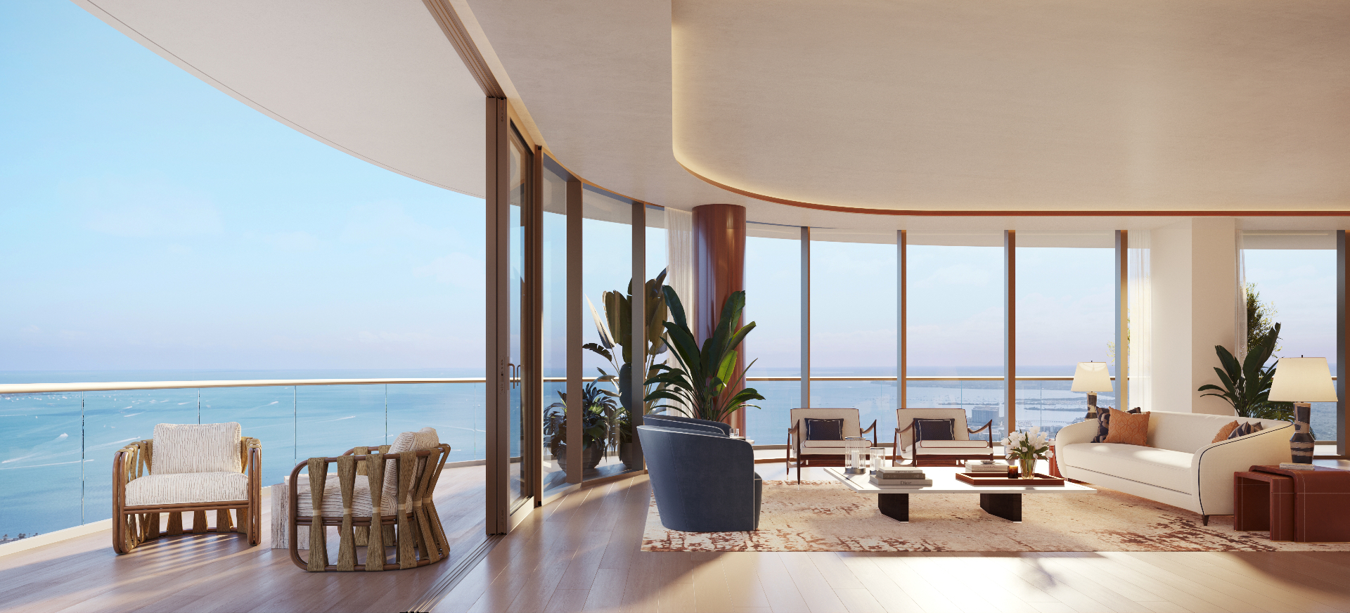 Curved bayfront living room in a Miami branded residence with floor-to-ceiling glass and Biscayne Bay view