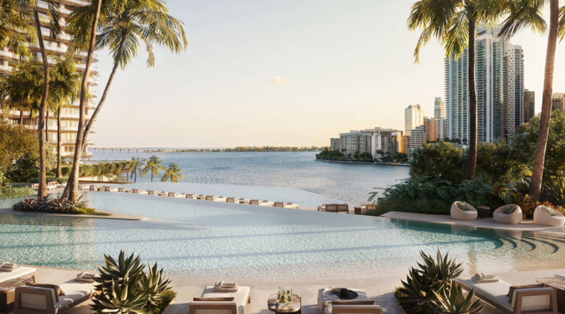 Mandarin Oriental Residences waterfront infinity pool deck at sunset with Miami skyline