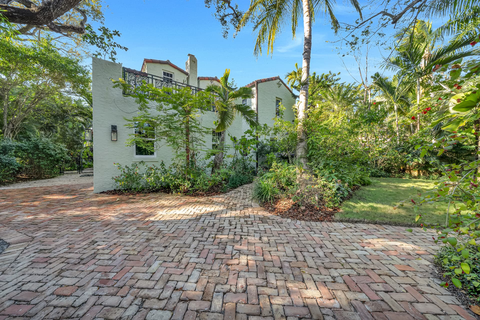 Old Spanish-style exterior and brick drive at 1720 Espanola Drive