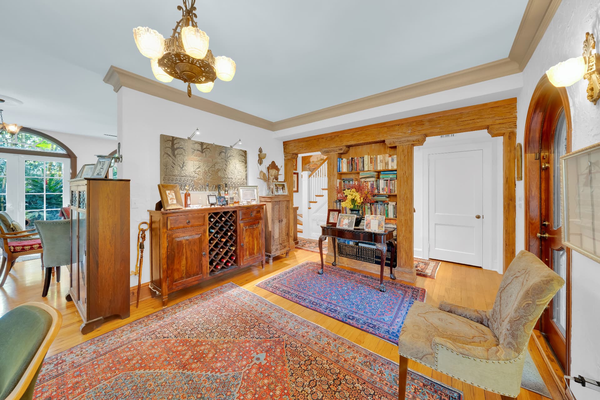 Living hall with carved wood millwork and library